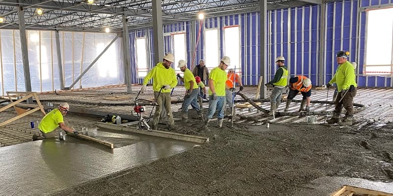 TBG Contracting crew pouring concrete on commercial site